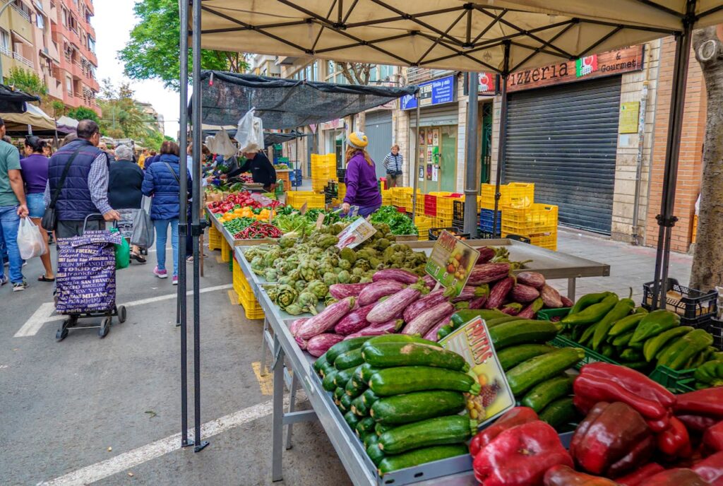 Discover vibrant market stalls with fresh produce in Alicante, Spains lively street atmosphere.
