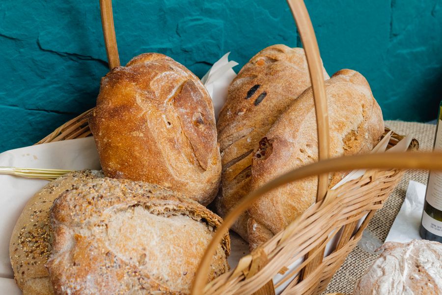 Pães artesanais variados em uma cesta de vime